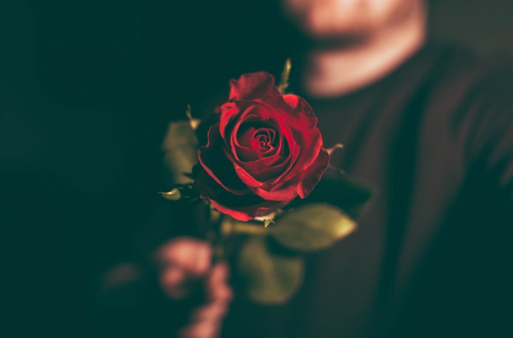 Man holding out a rose