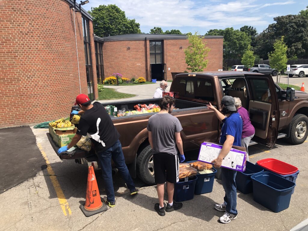 Volunteers of food bank unloading food